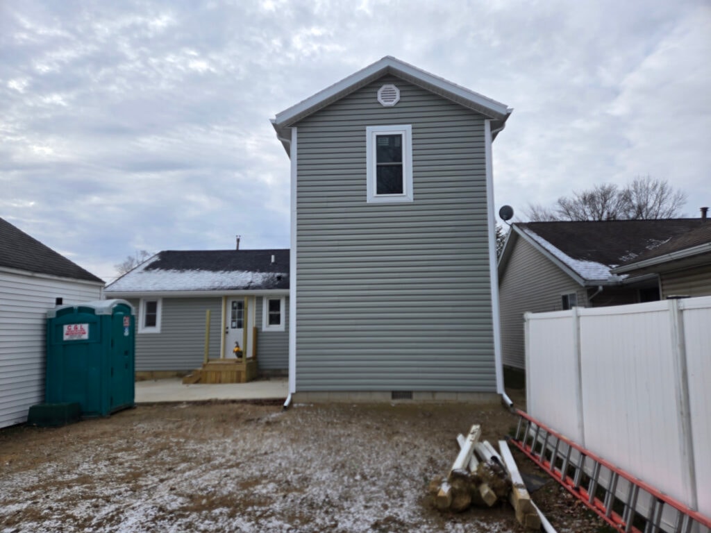 2 story home addition — rear exterior near completion with gray siding and porta-potty — Findlay, Ohio