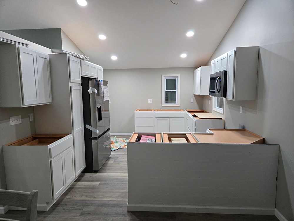 2 story home addition — kitchen in progress with white cabinets and vaulted ceiling — Findlay, Ohio