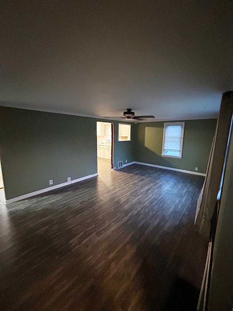 2 story home addition — completed living room with sage green walls and new flooring — Findlay, Ohio