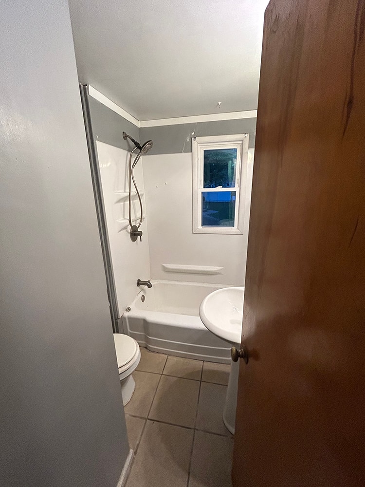 2 story home addition — before: original bathroom with tub and tile floor — Findlay, Ohio