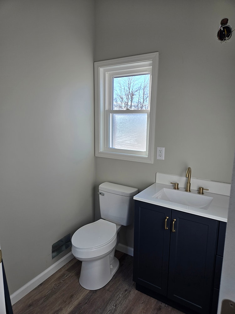 2 story home addition — completed upstairs bathroom toilet and vanity with window — Findlay, Ohio