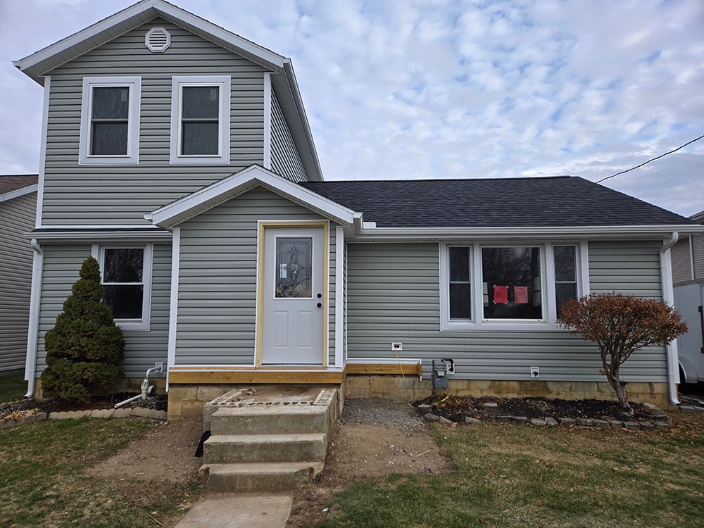 2 story home addition — completed front exterior with gray siding and new entry — Findlay, Ohio