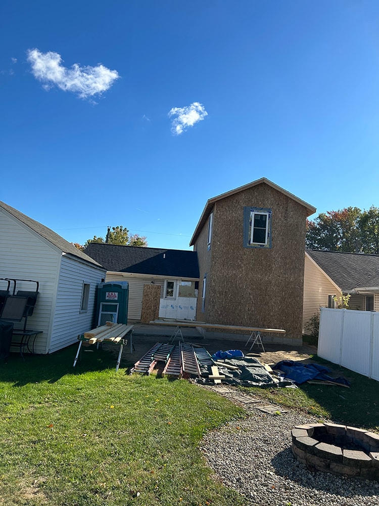 2 story home addition — framing stage rear yard view with fire pit — Findlay, Ohio