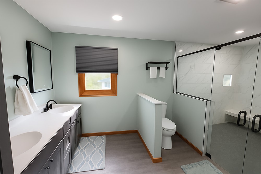 Siding, bathroom, garage & 1/2 bath — after: completed master bathroom with walk-in shower, vanity, and sage green walls — Attica, Ohio
