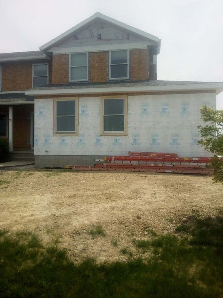 Siding, bathroom, garage & 1/2 bath — during: new addition framing and sheathing on front elevation — Attica, Ohio