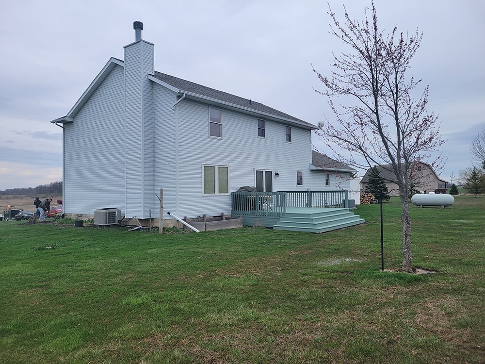 Siding, bathroom, garage & 1/2 bath — before: original rear/side view of home with teal deck — Attica, Ohio