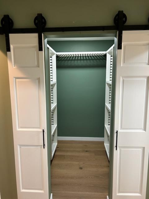 Bathroom/closet addition — after: walk-in closet interior with green walls, white shelving, and barn door hardware — Findlay, Ohio