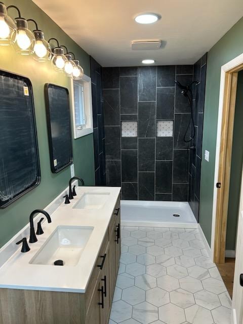 Bathroom/closet addition — after: master bathroom with double vanity, dark tile shower, hexagonal floor tile, and green walls — Findlay, Ohio