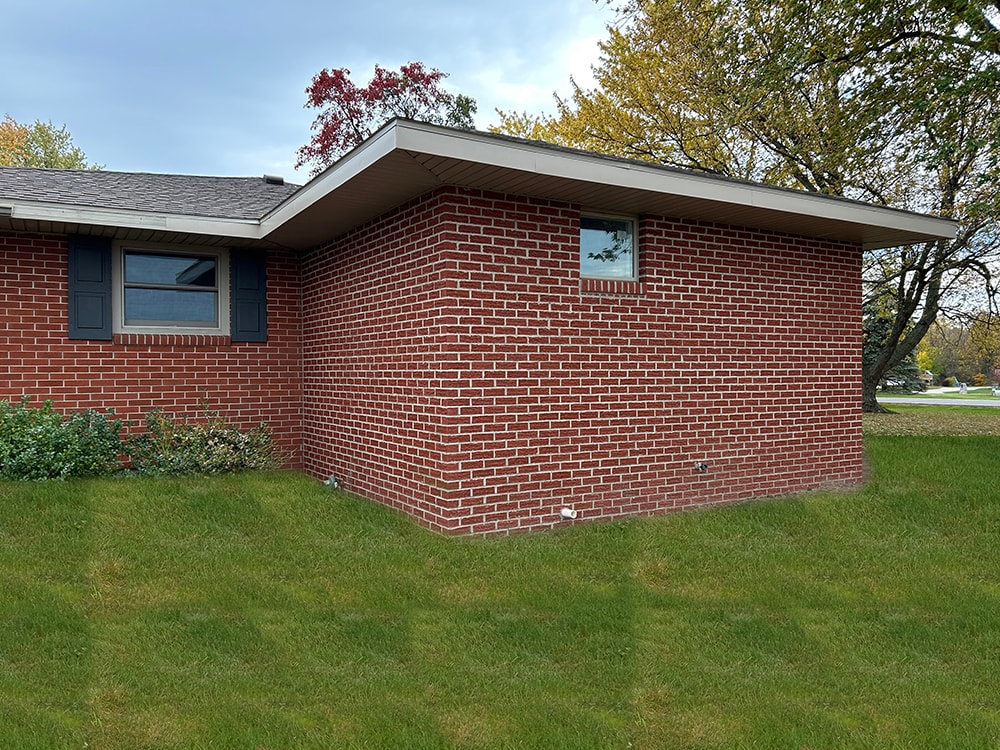 Bathroom/closet addition — after: completed brick addition side view with matching brick and blue shutters — Findlay, Ohio
