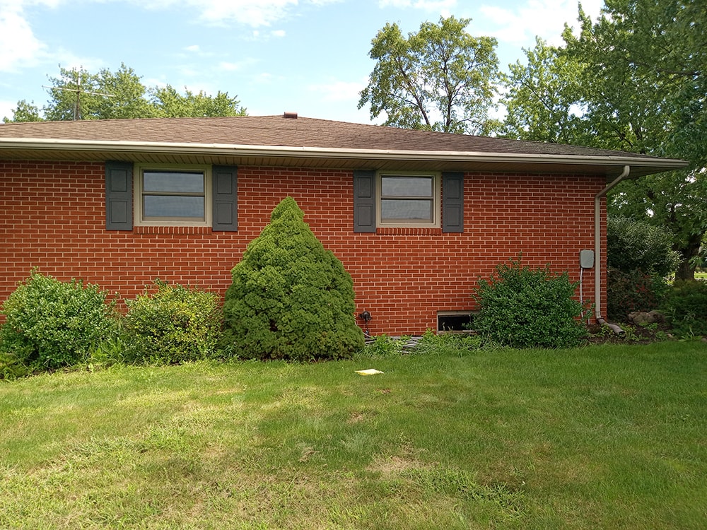 Bathroom/closet addition — before: original home rear view with mature landscaping and shutters — Findlay, Ohio