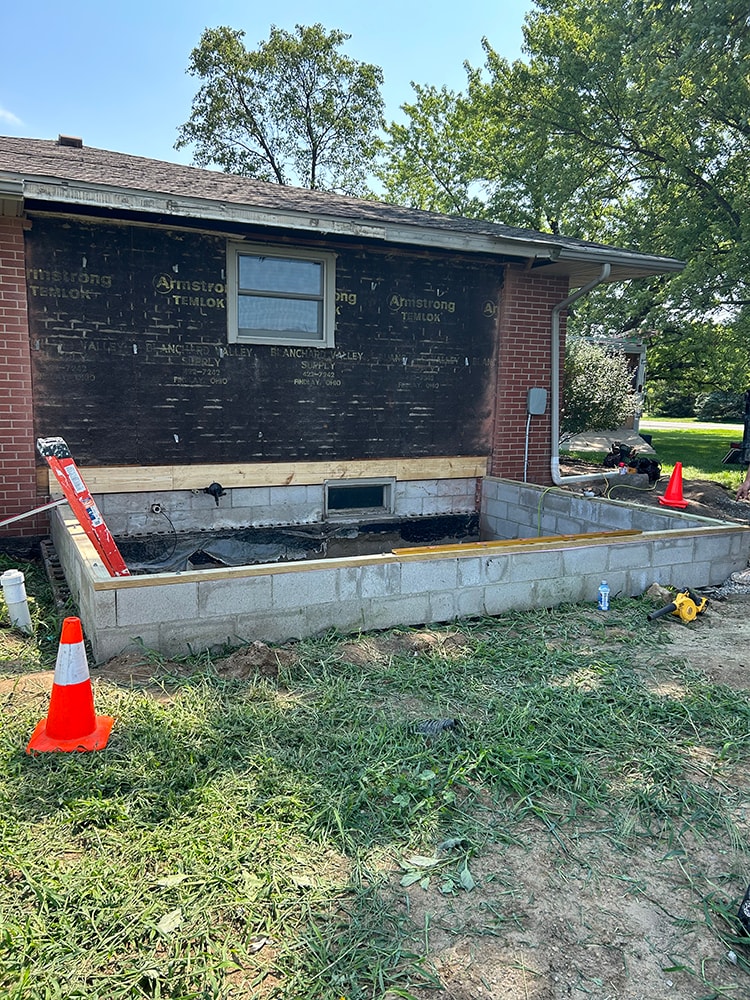 Bathroom/closet addition — during construction: foundation block walls and siding stripped from original home — Findlay, Ohio