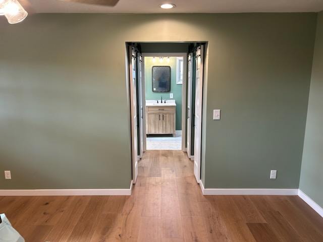Bathroom/closet addition — after: bedroom hallway view through to completed master bathroom with vanity — Findlay, Ohio
