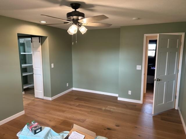 Bathroom/closet addition — after: completed master bedroom with sage green walls, hardwood floor, and closet entry — Findlay, Ohio