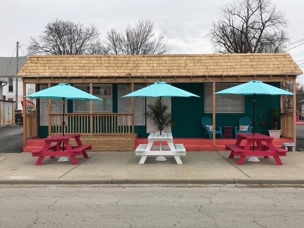 Cedar porch and overhang Findlay — after: finished exterior with turquoise umbrellas and colorful picnic tables, Findlay, Ohio