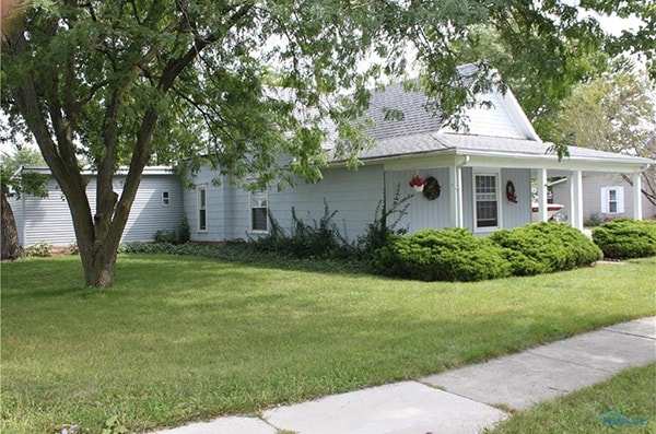 Completed exterior after full home remodel with new blue siding — Deschler, Ohio