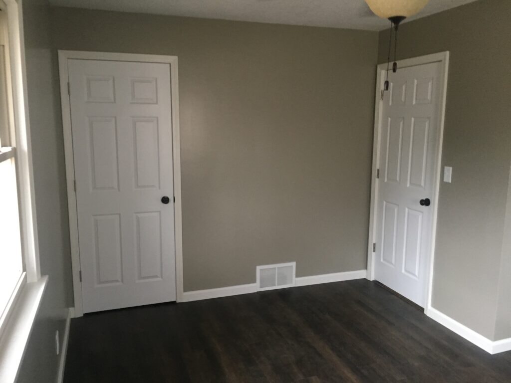 Complete home remodel Findlay — after: remodeled bedroom with new LVP flooring, interior doors and fresh paint, Findlay, Ohio