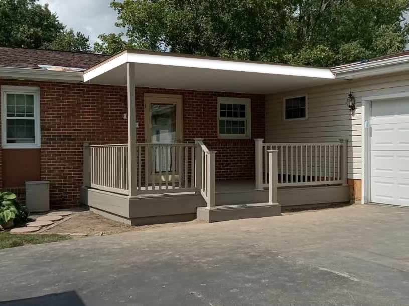 Composite deck with flat roof — after: completed deck and flat roof from street view with tan railing and side stairs — Findlay, Ohio
