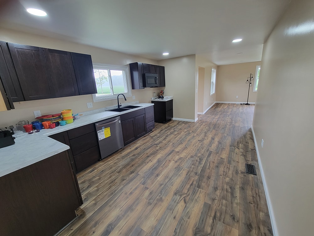 Entire house remodel — after: completed main floor hallway with new flooring and doors — Arlington, Ohio
