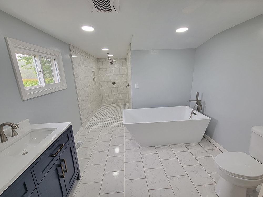 Entire house remodel — after: completed bathroom with new vanity, tile, and fixtures — Arlington, Ohio