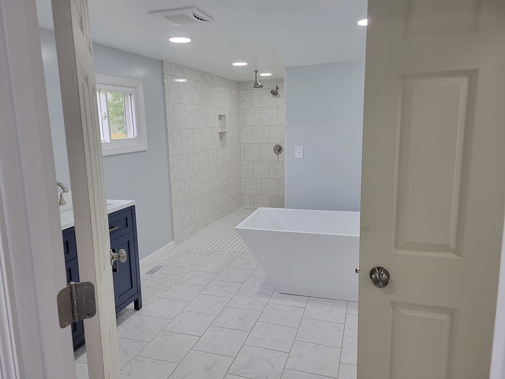 Entire house remodel — after: completed bedroom with new flooring and trim — Arlington, Ohio