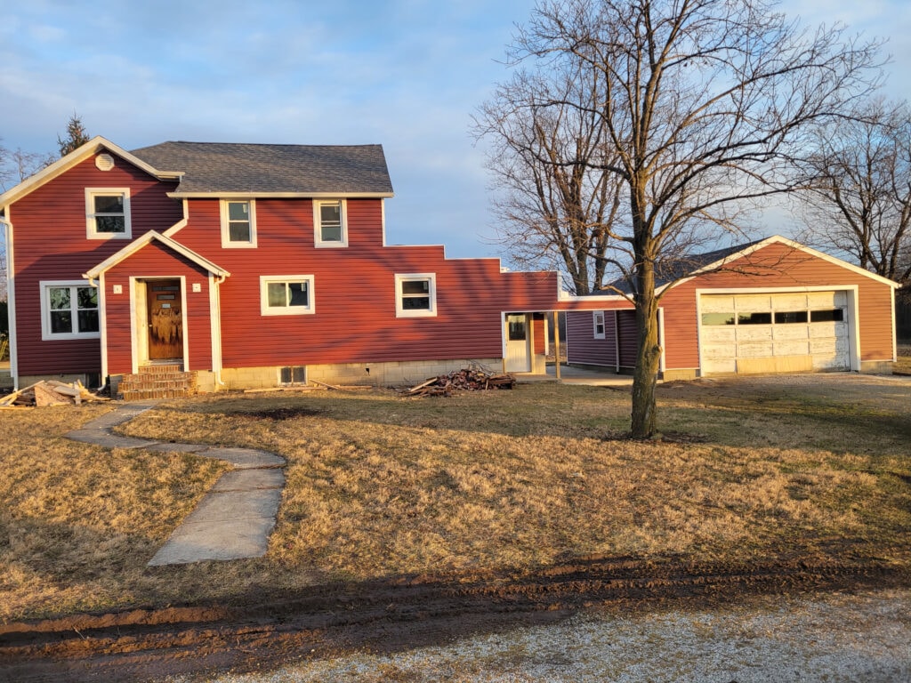 Entire house remodel — after: completed exterior view showing new siding on rear elevation — Arlington, Ohio