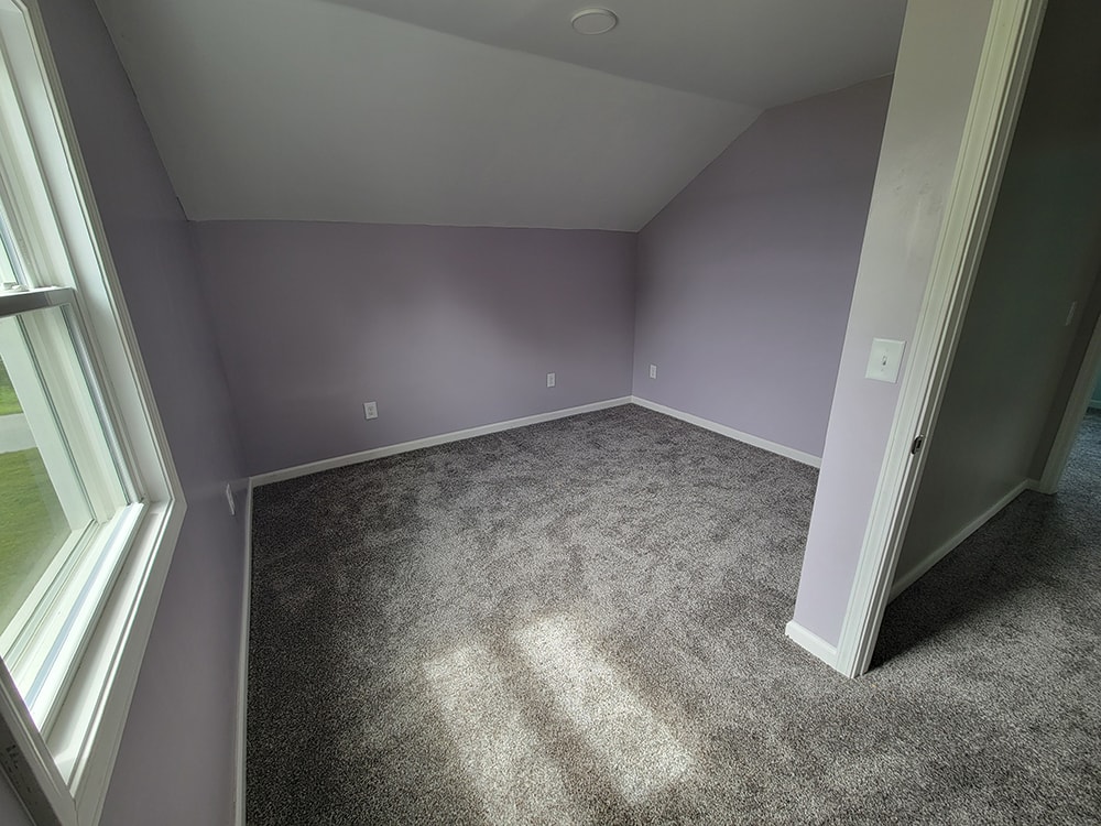 Entire house remodel — after: upstairs bedroom with lavender walls and gray carpet — Arlington, Ohio