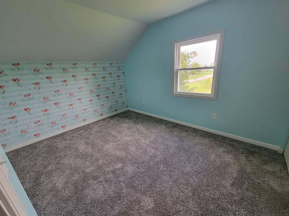 Entire house remodel — after: upstairs bedroom with teal/turquoise walls and mermaid wallpaper accent — Arlington, Ohio