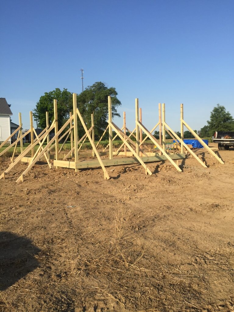 Garage build Arcadia — during: wall posts and bracing laid out on the ground ready for framing, Arcadia, Ohio