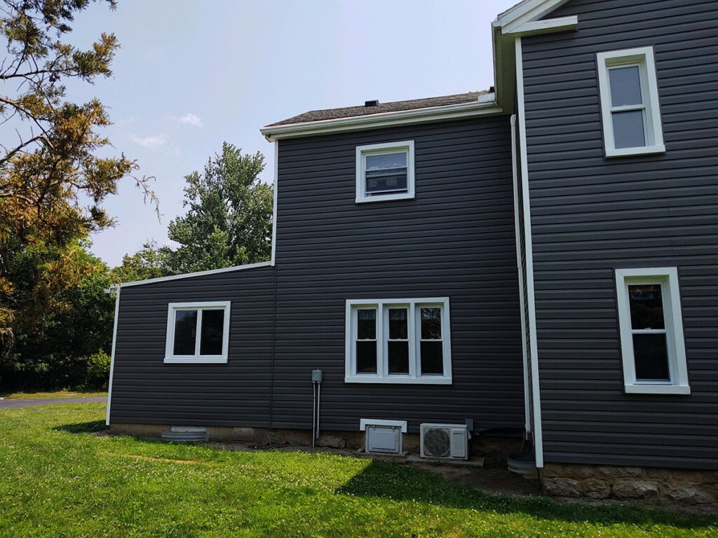 Hancock Park District siding — after: side view of Welcome Center with new dark charcoal siding, white trim, and multiple windows, Findlay, Ohio