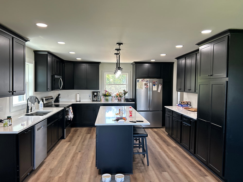 Completed kitchen remodel — dark cabinets, white countertops, and island — Findlay, Ohio