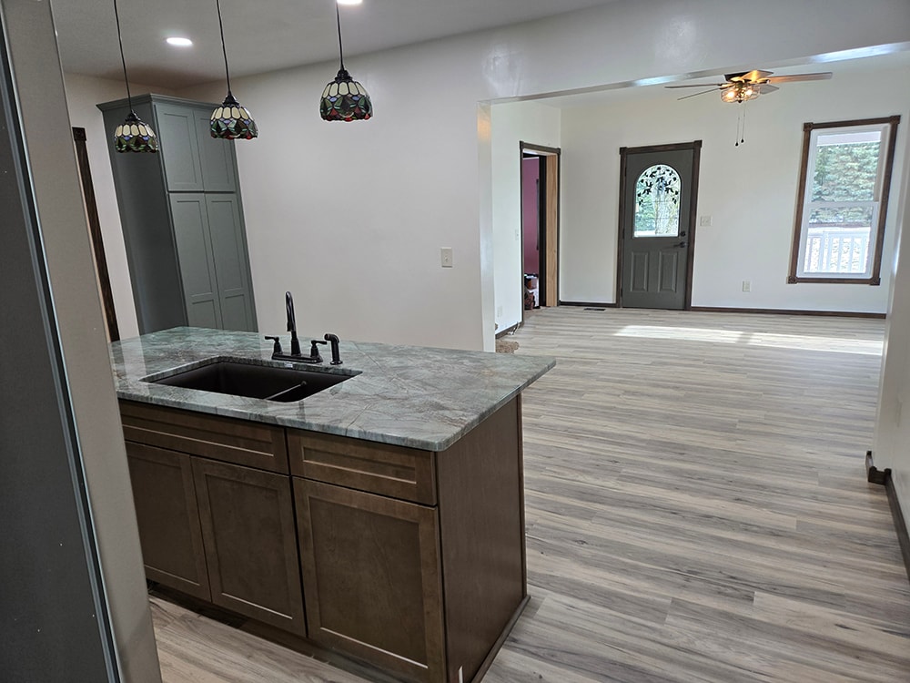 2 additions home remodel — after kitchen island view into open living room — Findlay, Ohio
