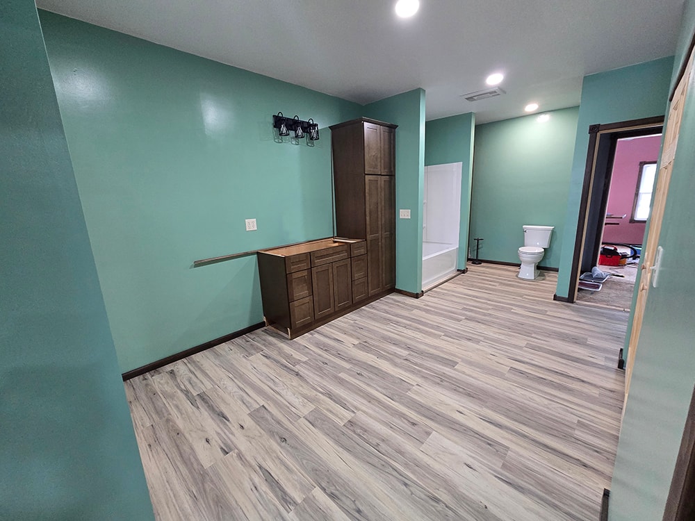 2 additions home remodel — bathroom in progress wide view with flooring — Findlay, Ohio