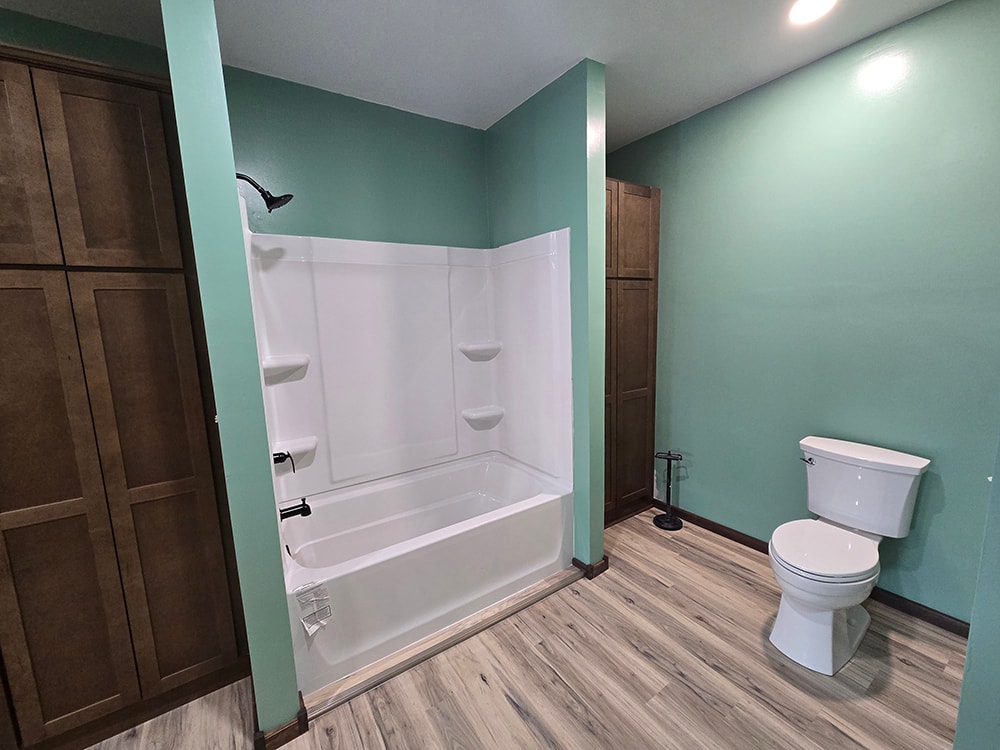 2 additions home remodel — completed bathroom tub and toilet with mint walls — Findlay, Ohio