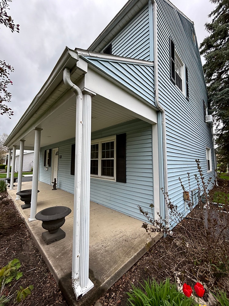 New siding — during: side view showing new window wrapping and trim installation in progress, rural Ohio
