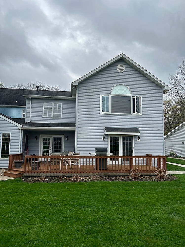 New siding — during: side of home with new siding installation underway and scaffolding visible, rural Ohio