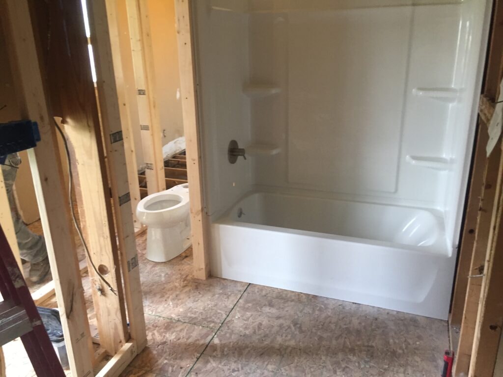 Kitchen family room remodel Arcadia — during: new bathtub surround and toilet rough-in with fresh subfloor, Arcadia, Ohio