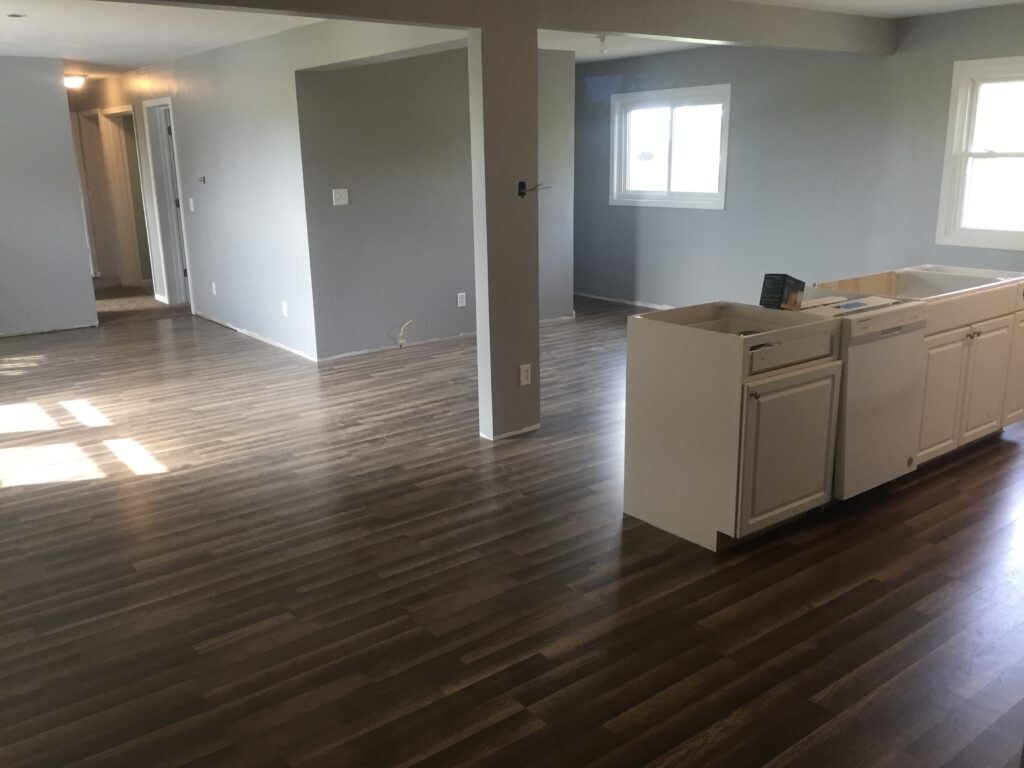 Kitchen family room remodel Arcadia — near complete: new luxury vinyl plank flooring and kitchen cabinets being installed, Arcadia, Ohio
