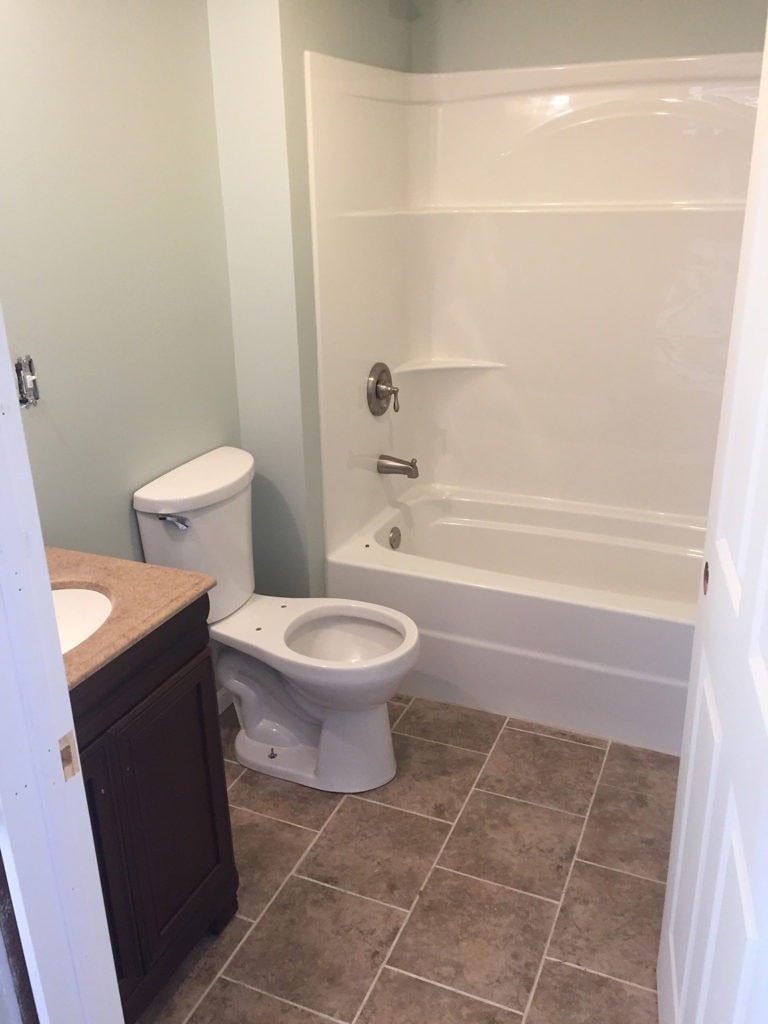 Kitchen family room remodel Arcadia — after: finished bathroom with new tub surround, vanity, and tile floor, Arcadia, Ohio