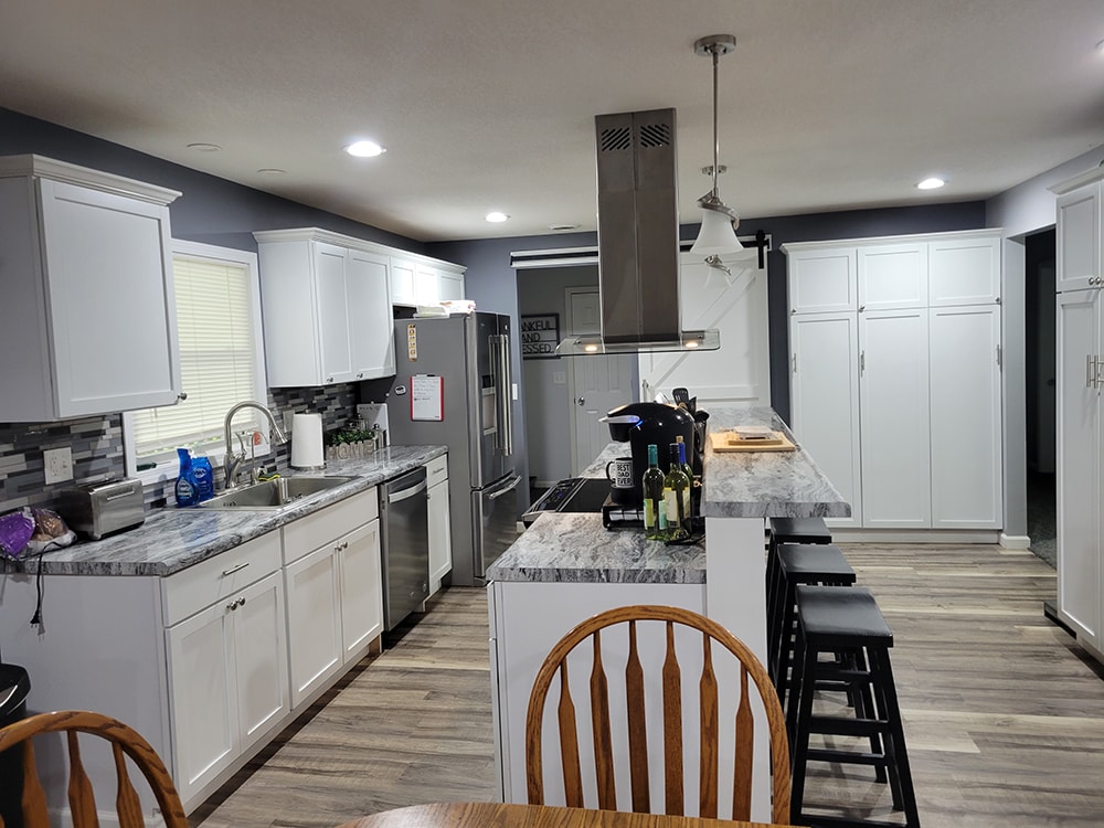 Remodeled kitchen with large island, stove, and stainless exhaust fan — Findlay, Ohio