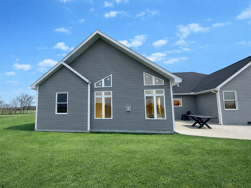 Large home addition exterior — completed with gray siding and large windows — Findlay, Ohio