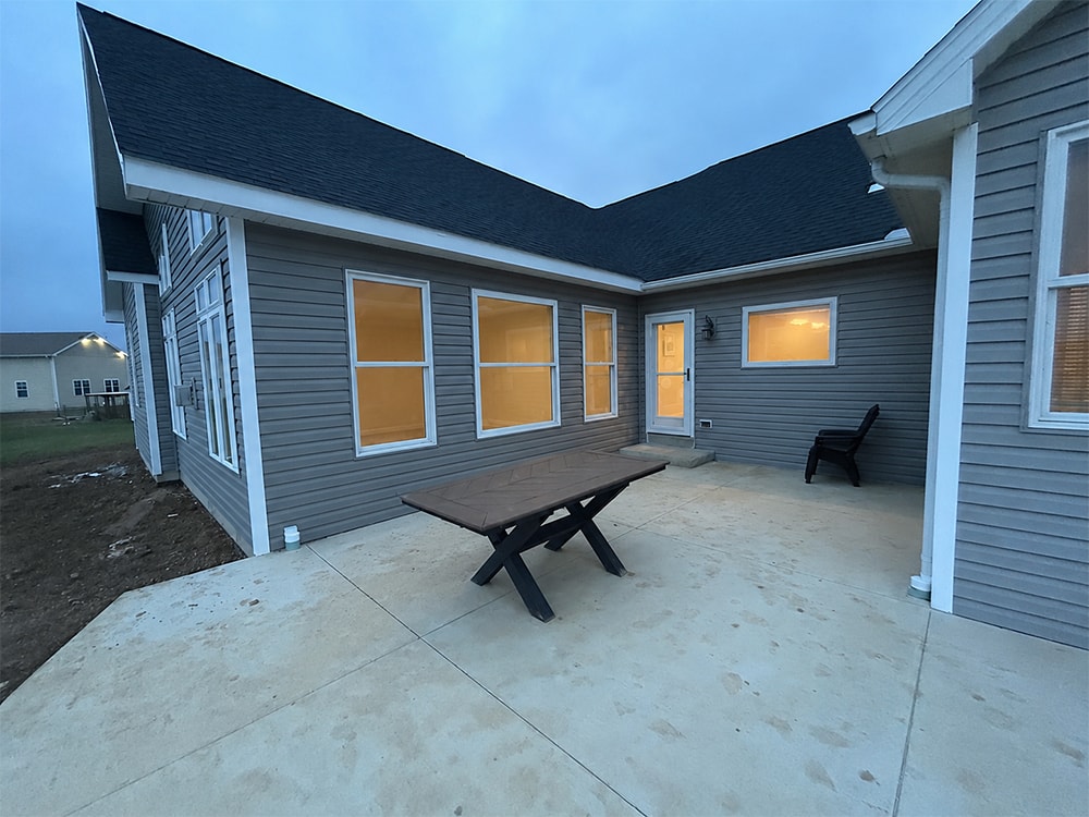 Large home addition exterior at dusk — new patio and rear elevation — Findlay, Ohio