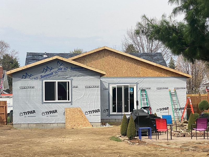 Large home addition — sheathed exterior with windows and patio door installed, Summit 60 underlayment on roof, Findlay, Ohio