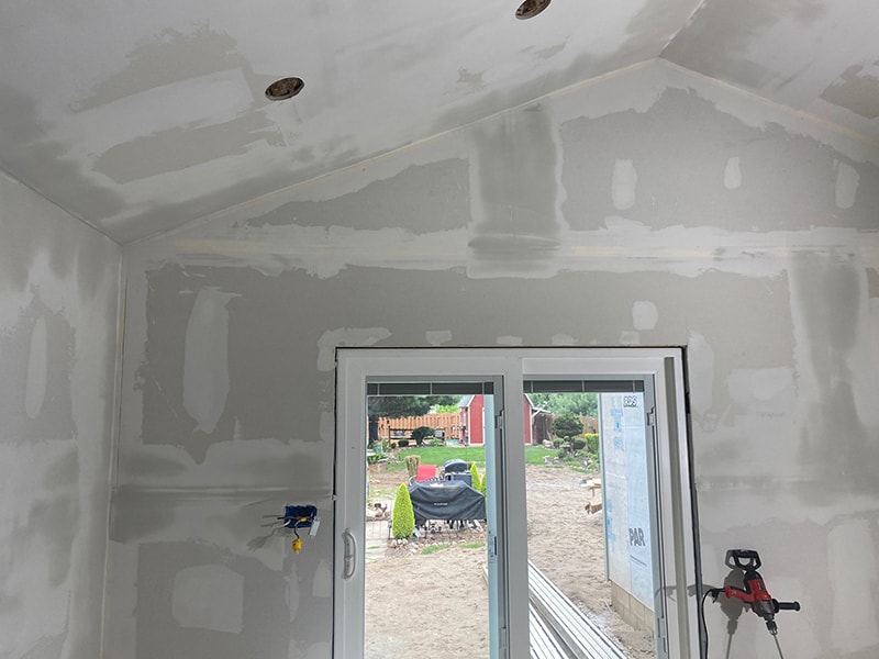 Large home addition — interior drywall mudded and sanded with patio door installed, vaulted ceiling roughed in, Findlay, Ohio