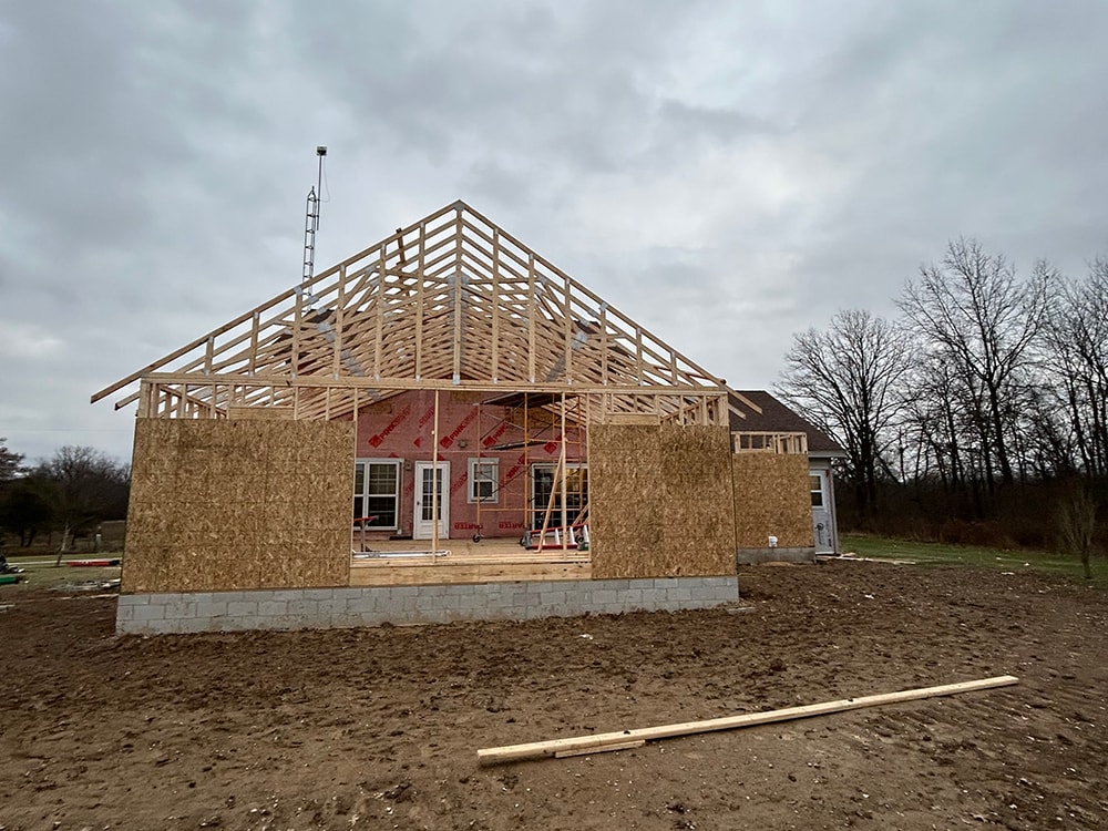 Large home addition — framing stage front view with roof trusses — Findlay, Ohio