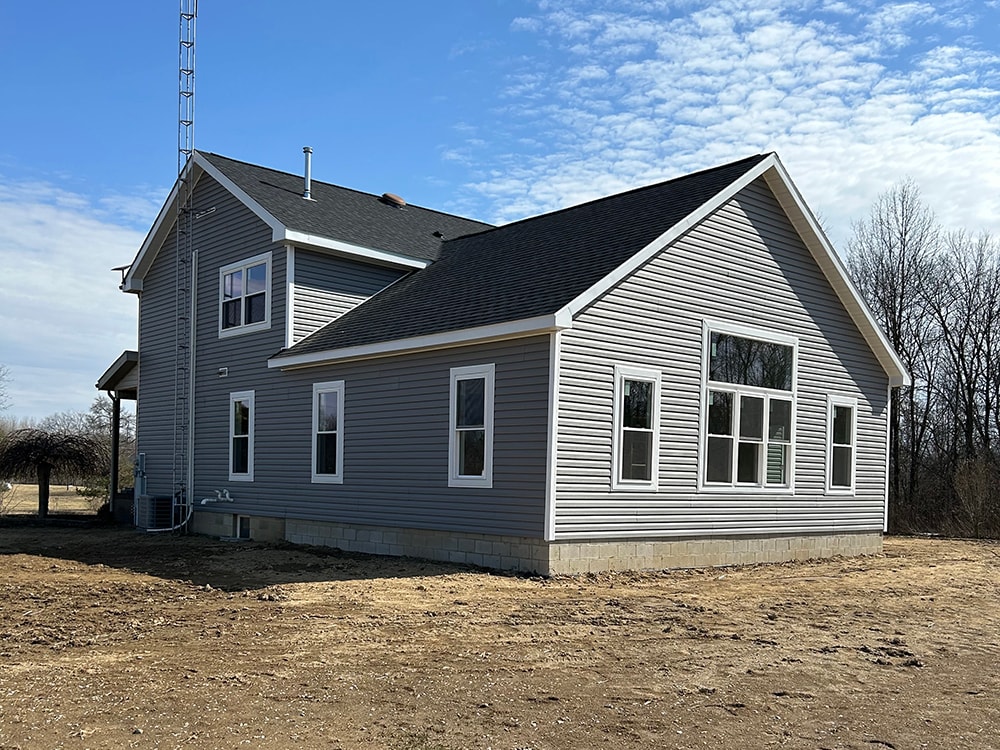Large home addition — completed exterior with gray siding and new windows — Findlay, Ohio