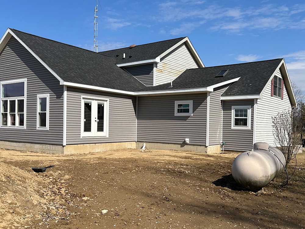 Large home addition — completed rear exterior with French doors and propane tank — Findlay, Ohio
