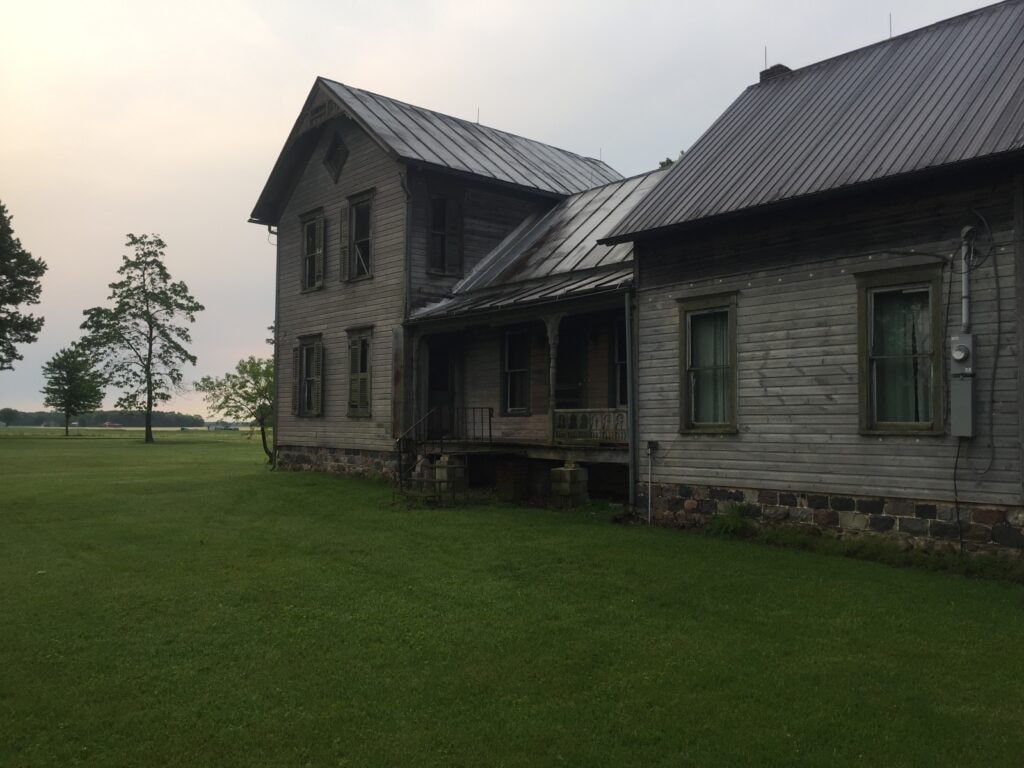 Front of home after metal roof, large garage and kitchen addition, and new siding — Gibsonburg, Ohio
