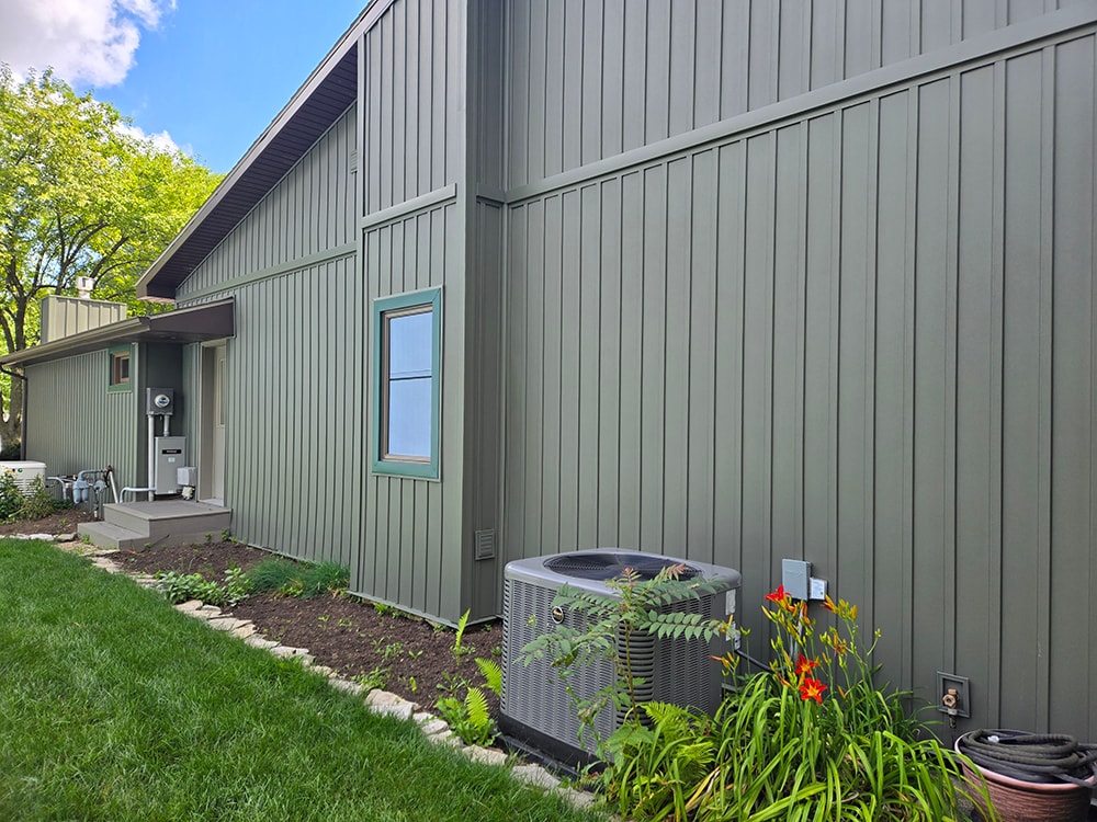 New board and batten siding — after: side view with new siding and AC unit — Findlay, Ohio