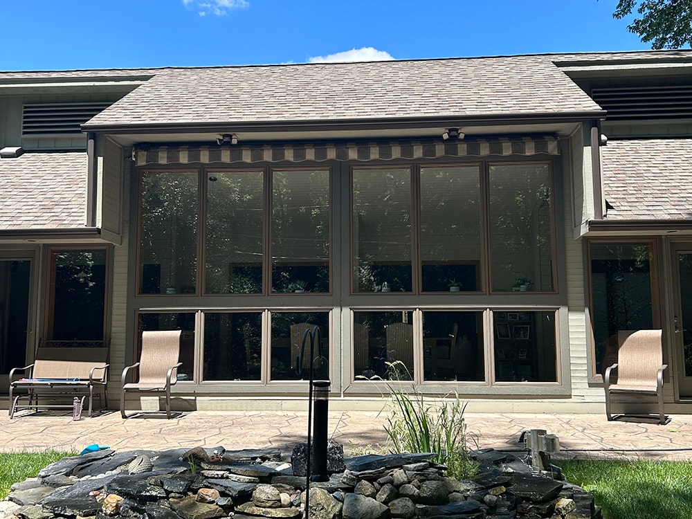 New board and batten siding — after: rear sunroom wall with new siding and patio furniture — Findlay, Ohio
