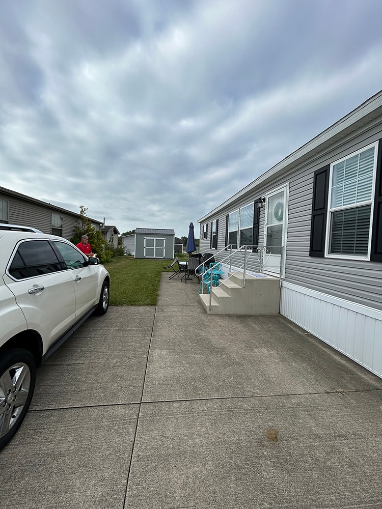 New composite deck with roof — before: mobile home side view with original steps — Findlay, Ohio
